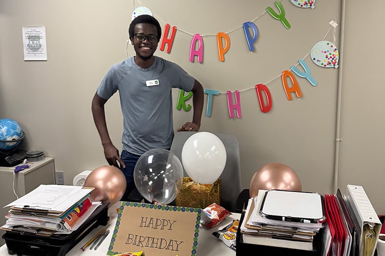 David at his desk with birthday decorations