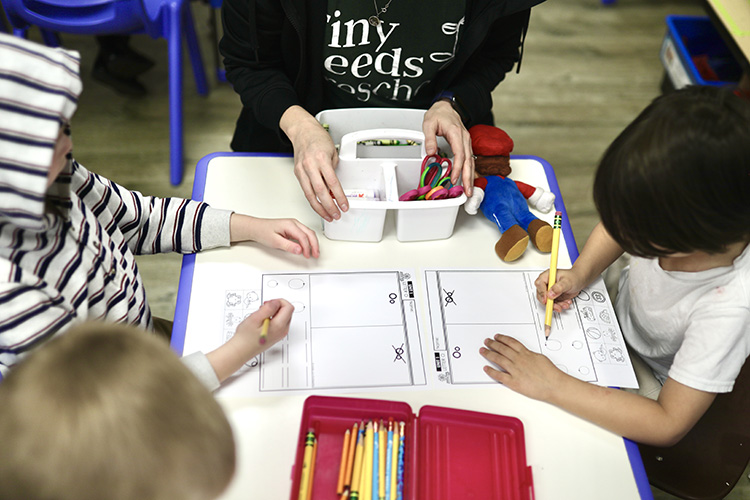 Tiny Seeds students working at a table